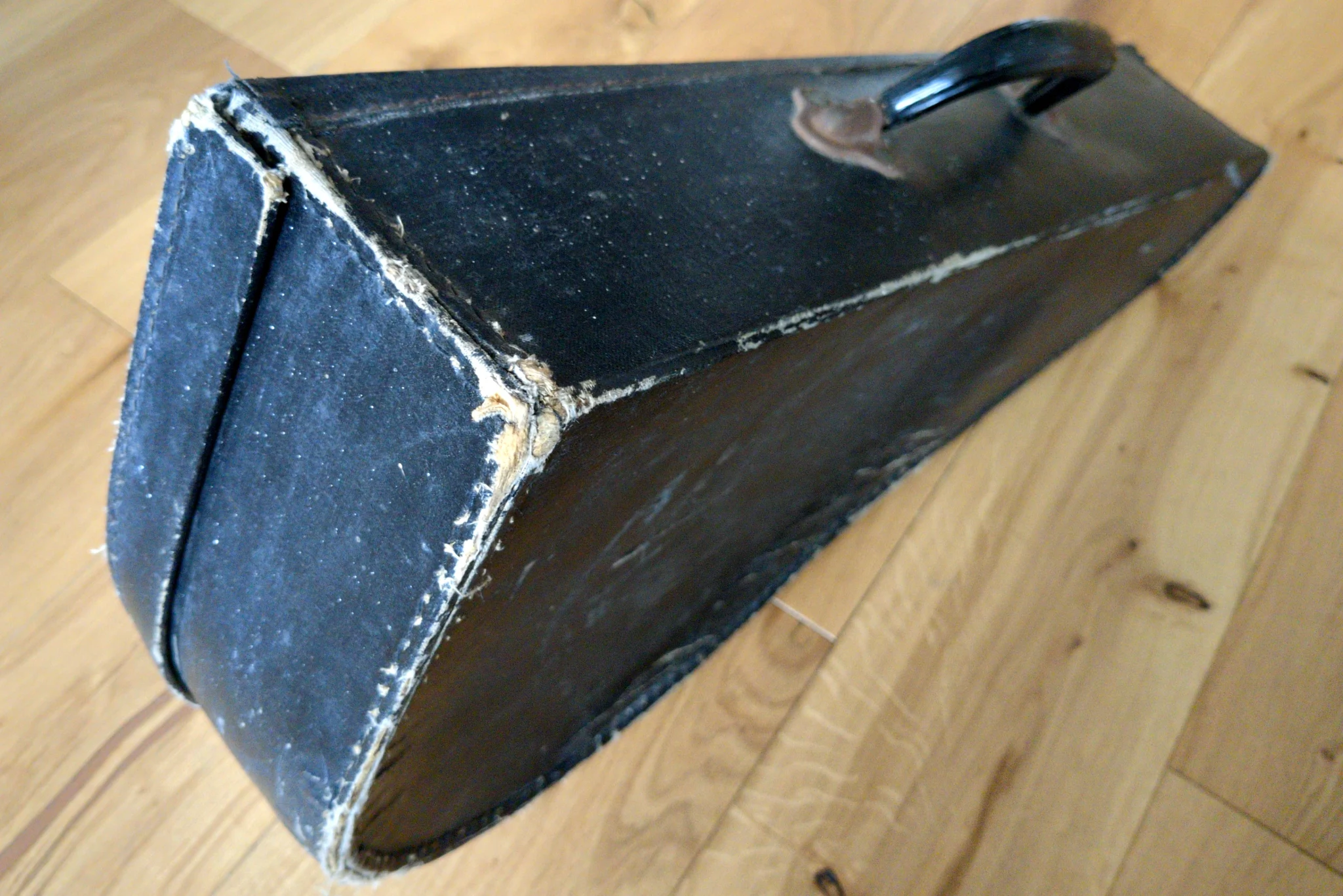 An old instrument case with a focus on one corner. There are marks where
is has been restitched, but it is holding together well.