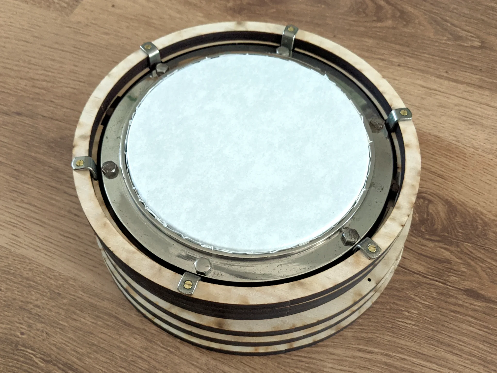 A stack of laser-cut rings with the tension ring screwed to the top and a
taut drumskin