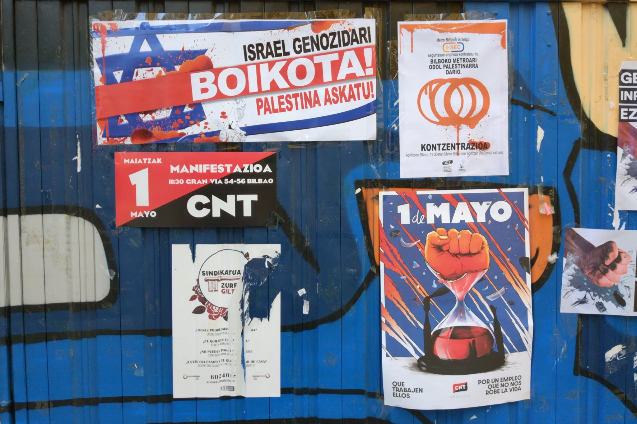 Flyers on a painted metal surface for a variety of political causes.