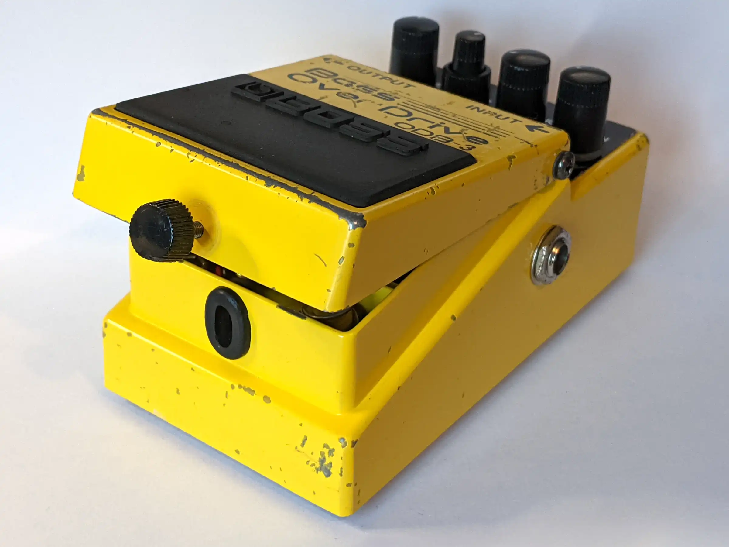 A Boss guitar (well, bass) effects pedal with the footswitch door opened
up and a new rubber grommet fitted to the aperture into which the thumbscrew
fits.