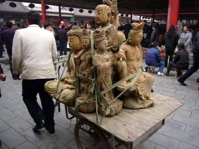 A cart full of Buddhas at Panjiayuan market