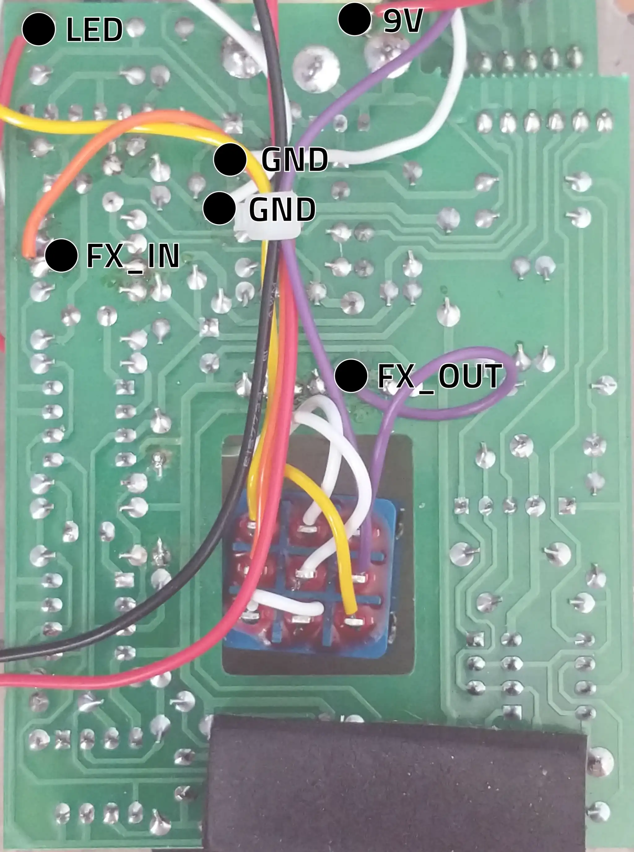A circuit board with various connection points marked