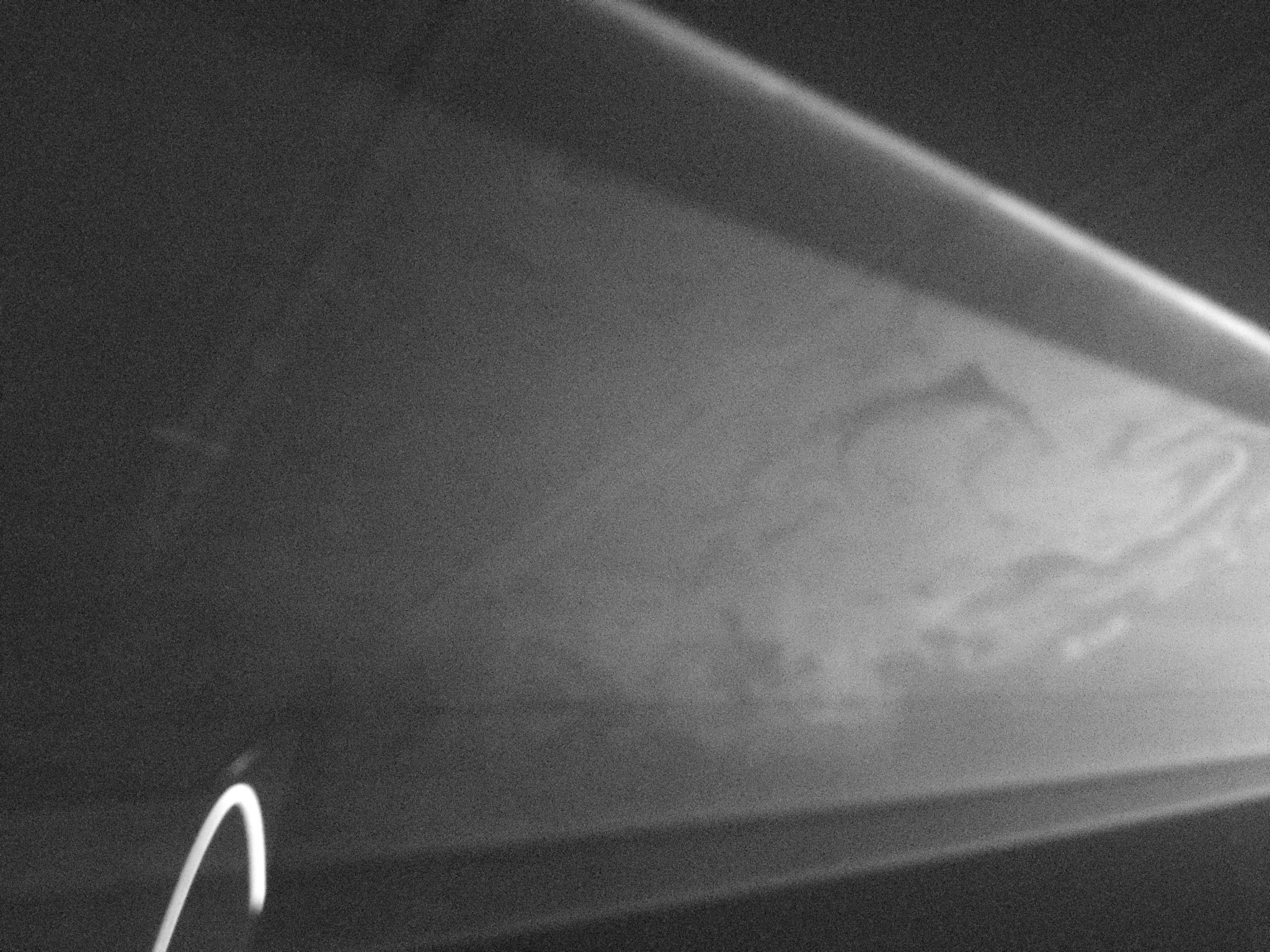 Beams of light diverge across a dark space