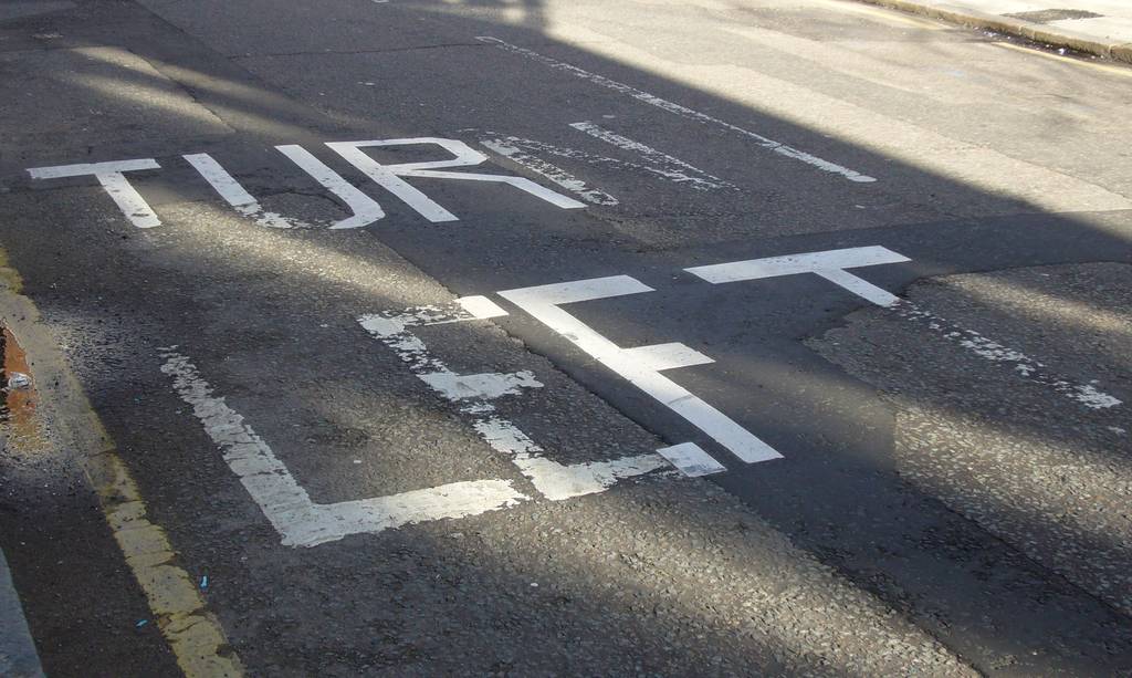 Partially repainted lettering on road